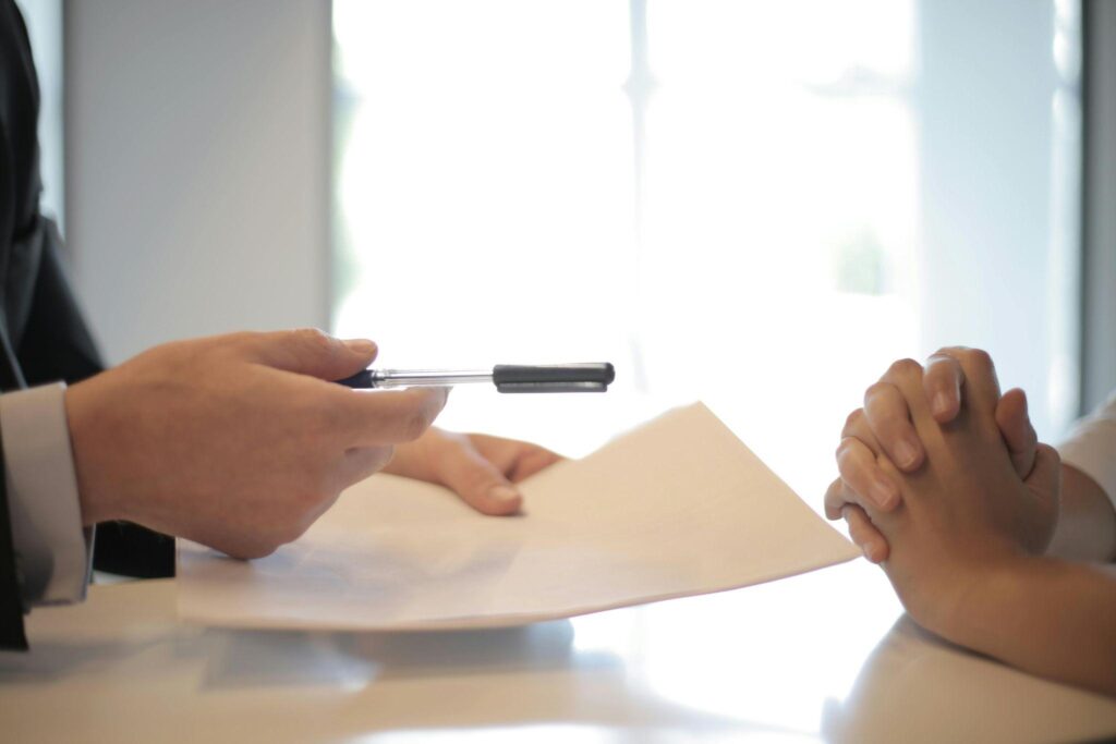 Marketing consultant reviewing documents with a client during a strategy consultation meeting focused on business growth and planning